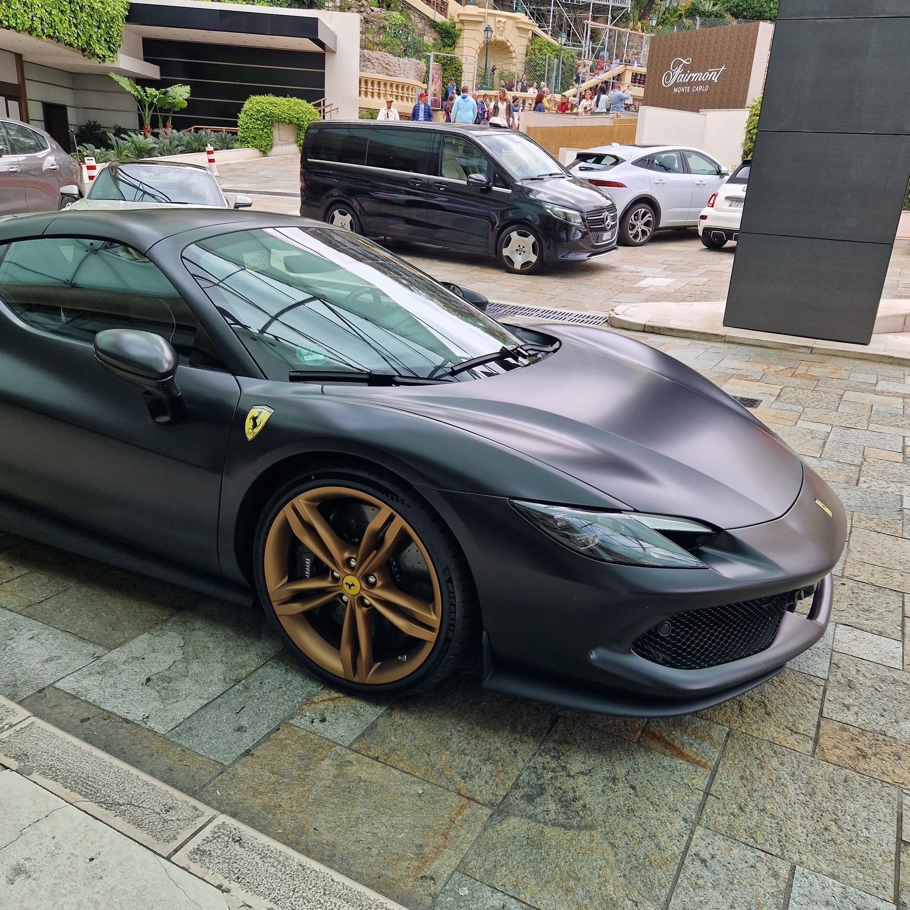 Μαύρη ματ Ferrari με χρυσές ζάντες παρκαρισμένη σε πλακόστρωτο
