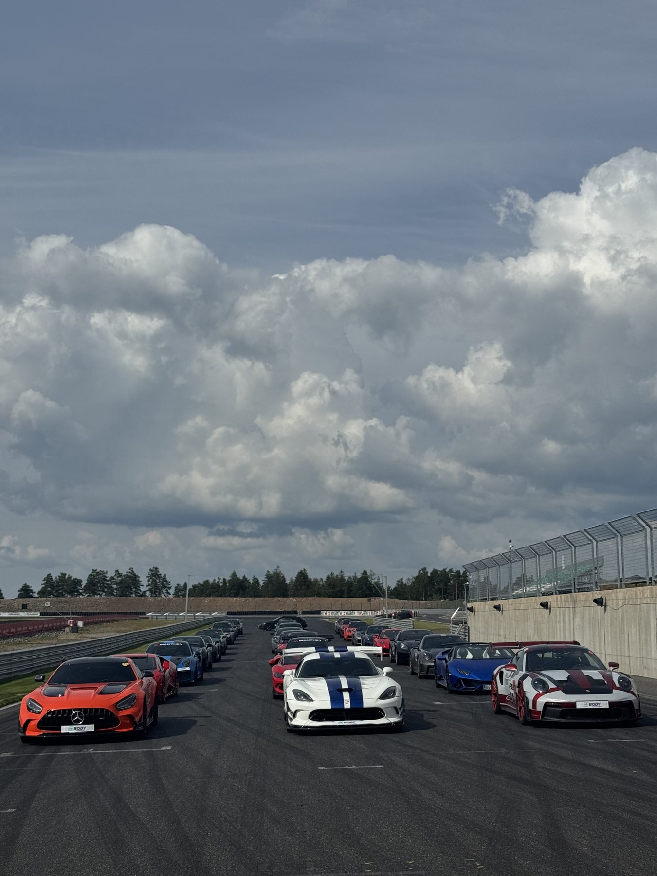 Αυτοκίνητα παραταγμένα στην pit lane της Rudskogen κάτω από συννεφιασμένο ουρανό